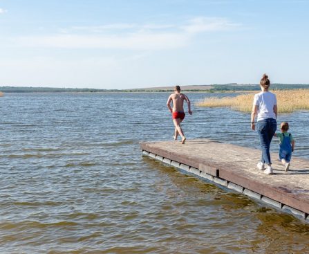 a man and a woman walking along a pier