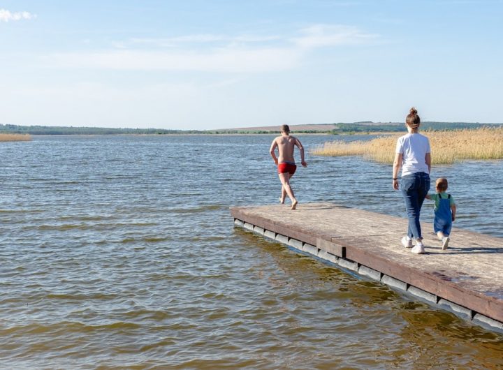 a man and a woman walking along a pier