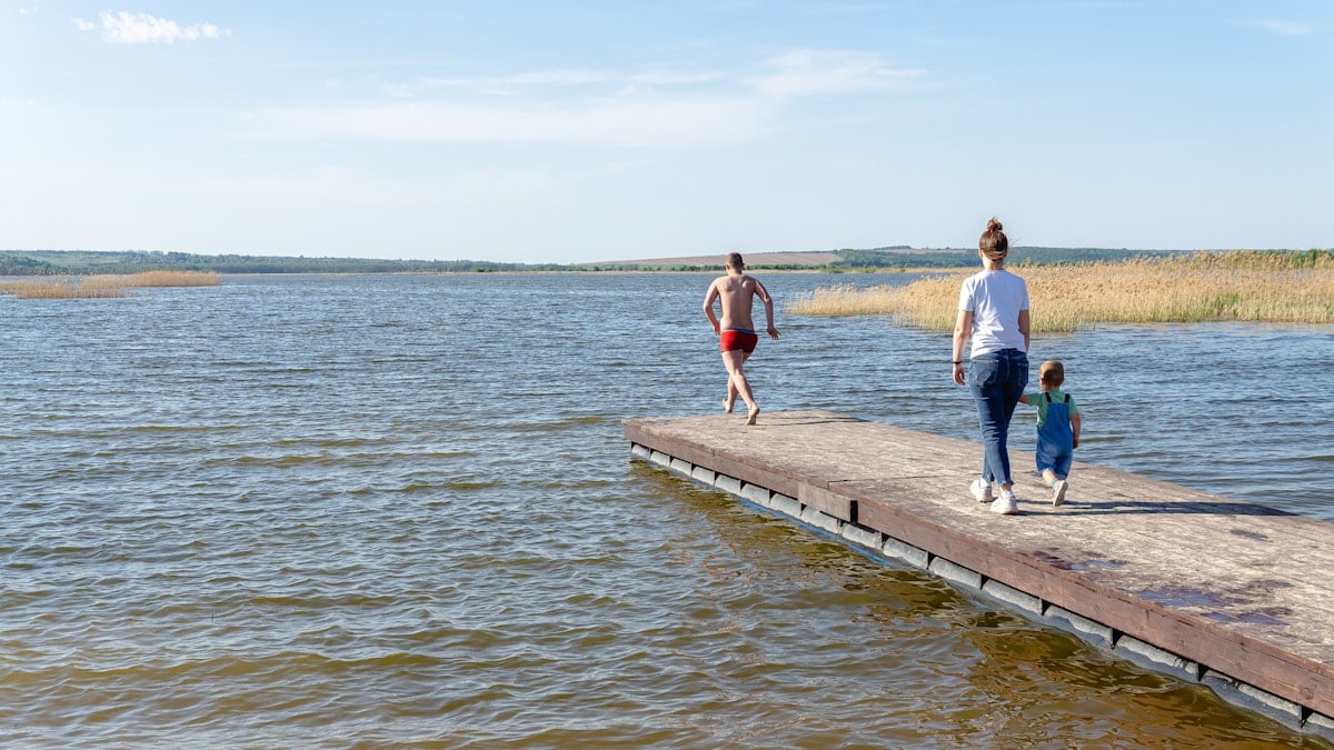 a man and a woman walking along a pier