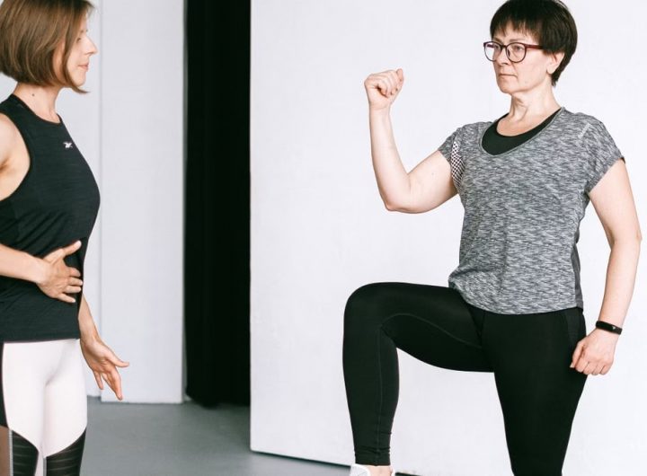 Two women working out together, demonstrating fitness exercises on a white background.